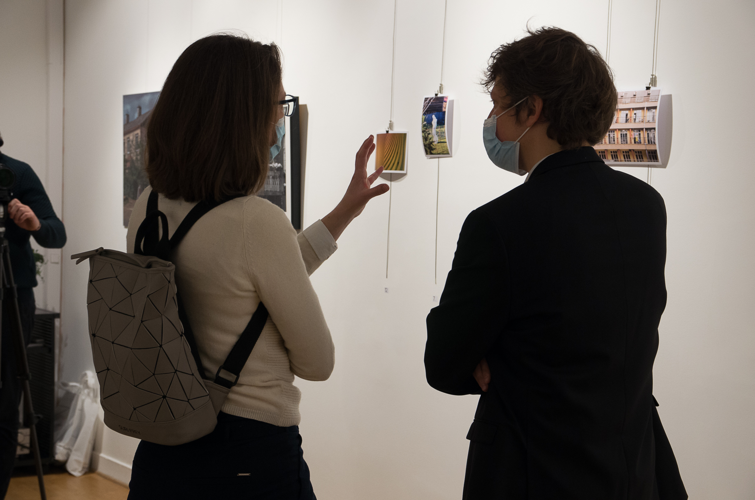 joint exibition in paris - two people looking on photographs