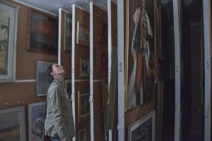 woman looking at panels with paintings